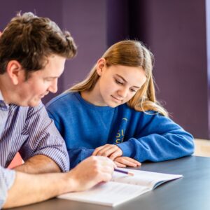 man teaching a young girl maths