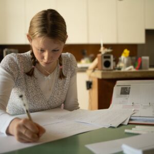 child studying on a table in a kitchen